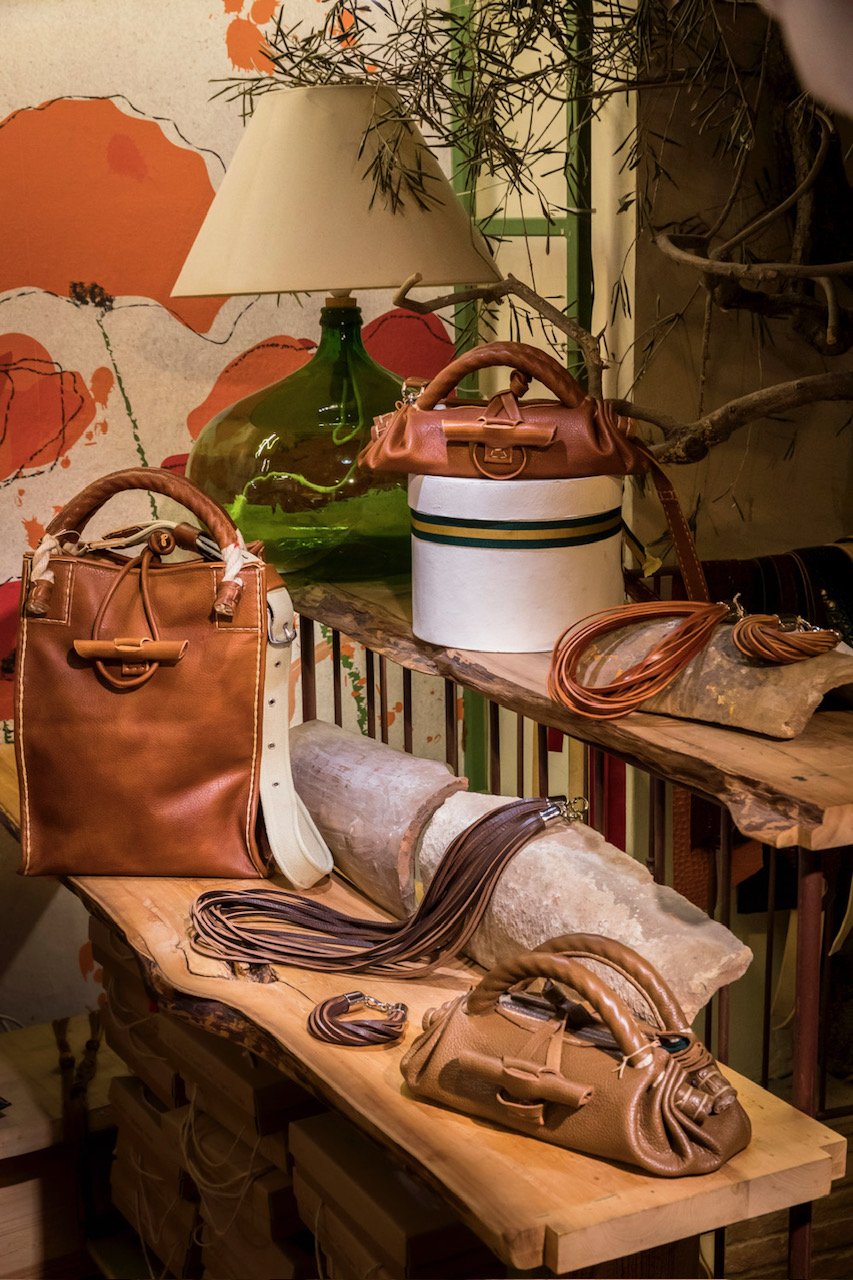 Finished leather goods lining the shelves of the Gli Aminti workshop